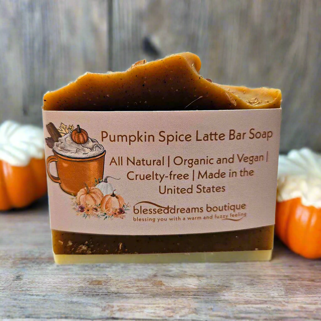Pumpkin Spice Latte Bar Soap with a label on a wooden surface with pumpkins in the background