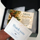A hand is placing a white 'Thank you' card into a black gift box with tissue paper and a Christmas greeting card inside.