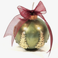 A Green Scented Wax Baubles Ornament with textured gold tree designs on the lower half, finished with a sheer burgundy ribbon bow and gold cap, set against a plain white background.