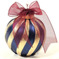 A Blue Scented Wax Baubles Ornament with alternating metallic gold and midnight blue stripes, topped with a large sheer burgundy ribbon bow on a white background.