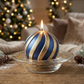 A Blue Scented Wax Baubles Ornament with striped gold glitter stripes.