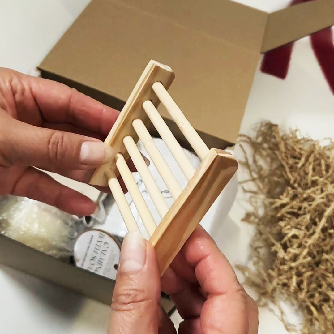 A person's hands holding a Bamboo Wood Soap Holder. The Cozy Moments Gift Box.