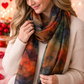 Woman wearing a colorful scarf with heart decorations in the background