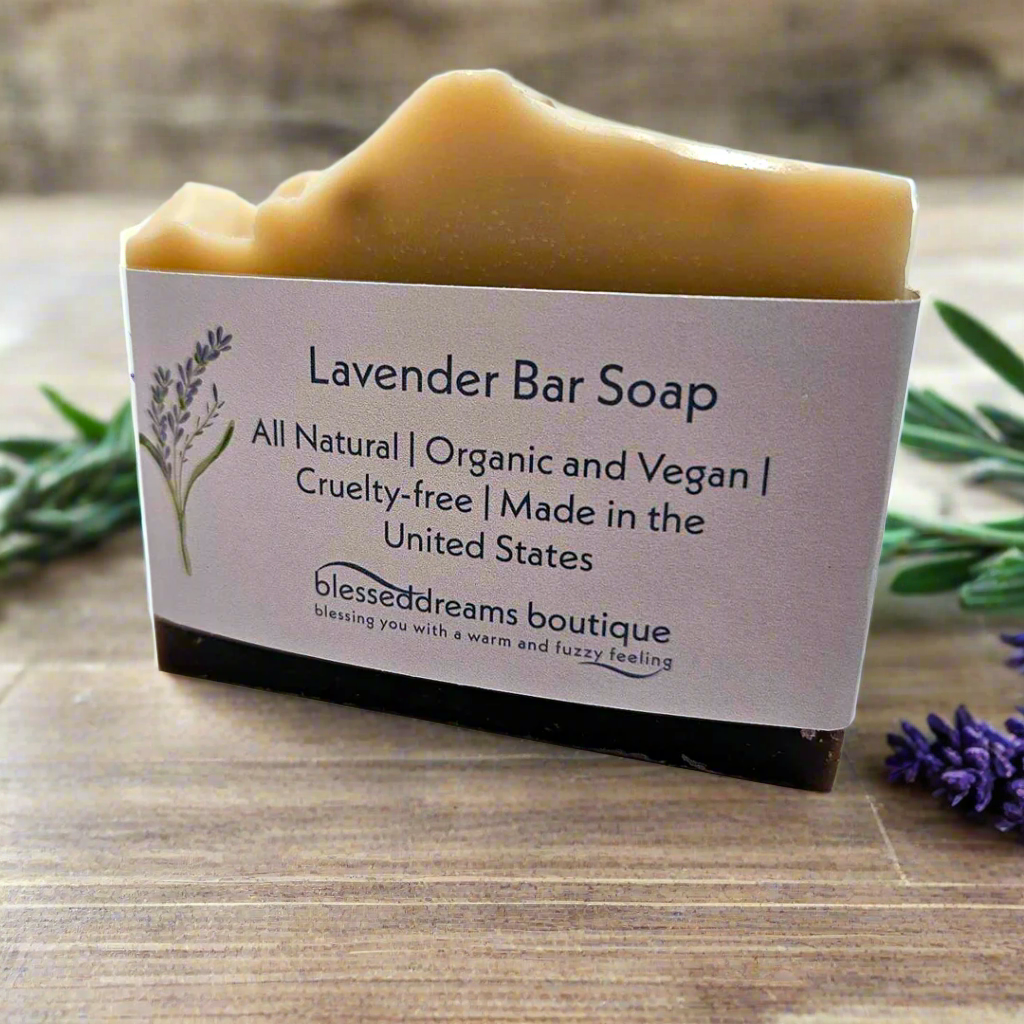 Lavender bar soap with a label on a wooden surface, surrounded by lavender flowers.