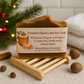 Pumpkin Spice Latte Bar Soap on a wooden stand with a Christmas tree in the background
