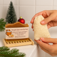 Pumpkin Spice Latte Bar Soap with a hand holding a loofah sponge in a bathroom setting.
