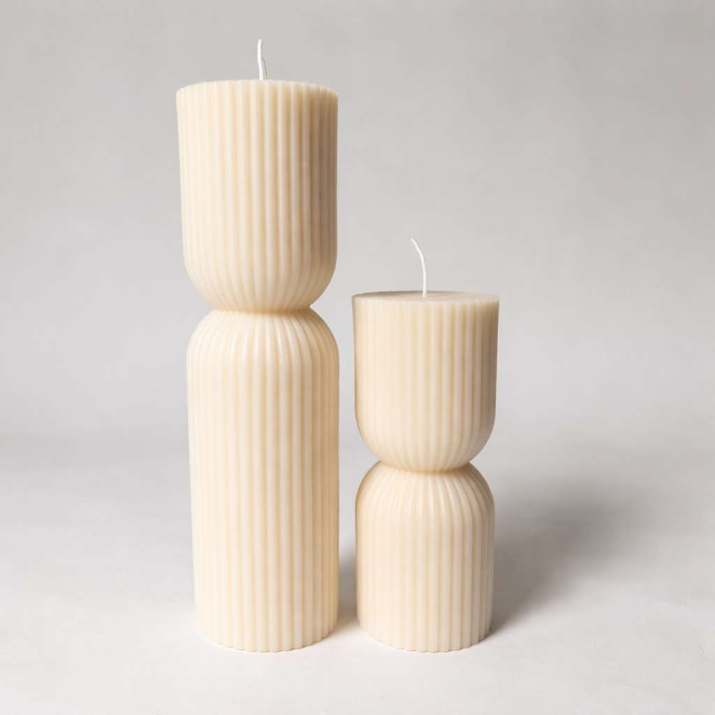 Set of ribbed hourglass pillar candles on a light gray background