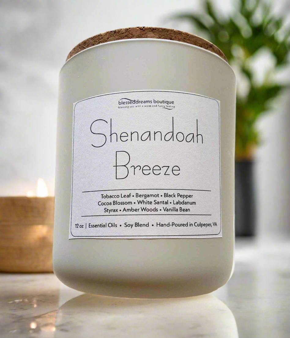 Candle labeled 'Shenandoah Breeze' with a cork lid on a marble surface.