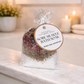 Sore Muscle Bath Soak package on a marble surface with candles and plants in the background