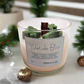 Yuletide Bliss - Wood Wick Soy Candle with green tree, cane and snowflake christmas decor on top of the candle.