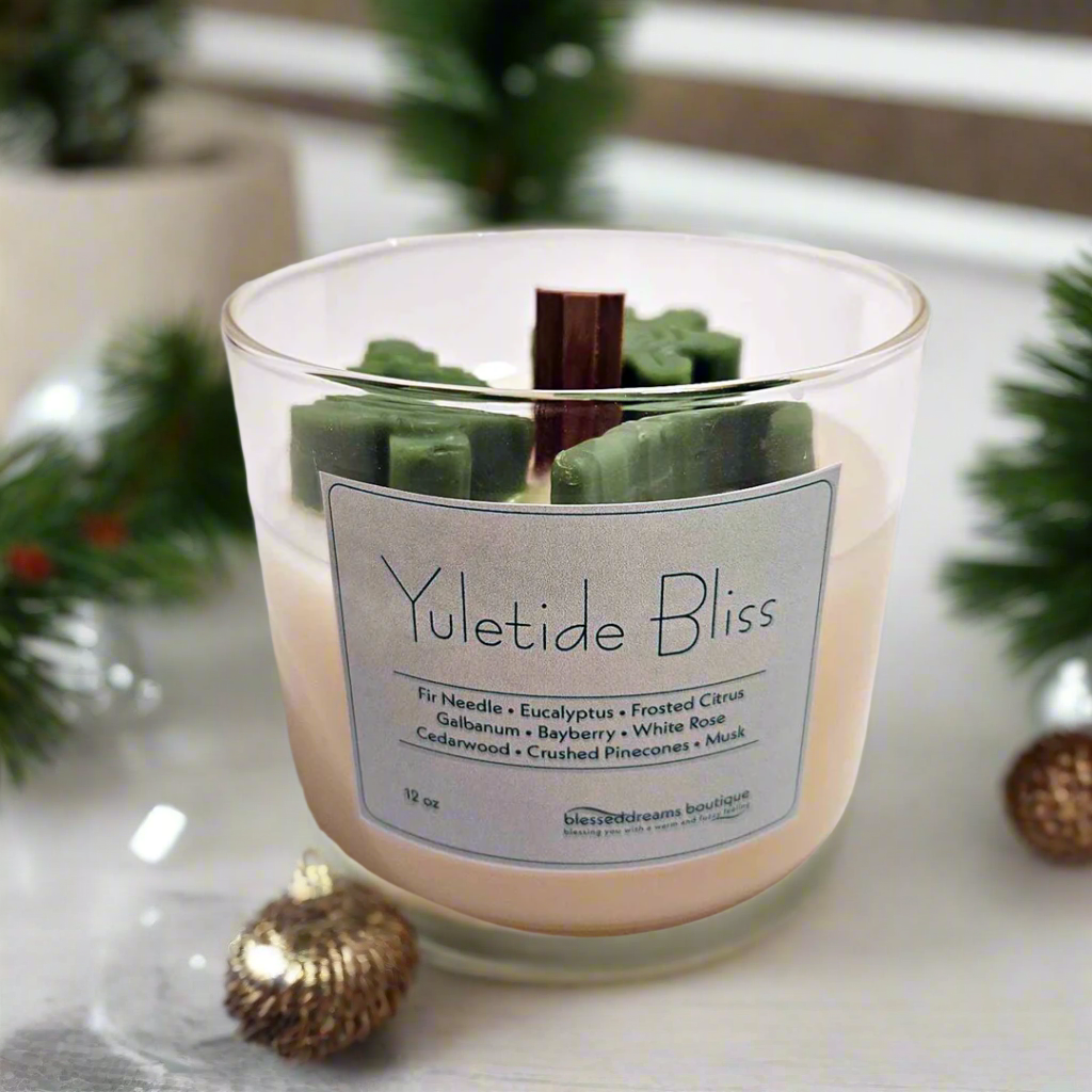 Yuletide Bliss - Wood Wick Soy Candle with green tree, cane and snowflake christmas decor on top of the candle.