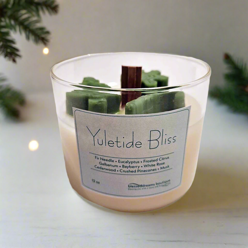 Yuletide Bliss - Wood Wick Soy Candle with green tree, cane and snowflake christmas decor on top of the candle.