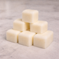 Stack of white wax melts on a light gray surface